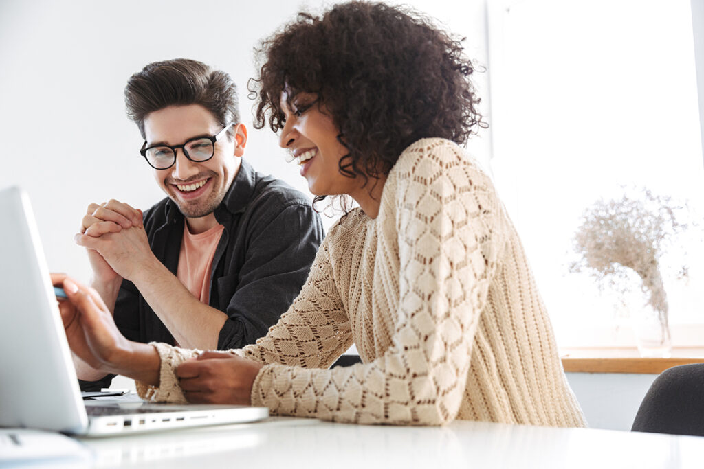 co-workers in front of a computer